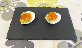 Eggs stuffed with guacamole with salmon caviar