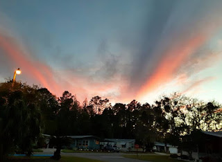 A fiery sunset over Cypress Lakes 55+ park.