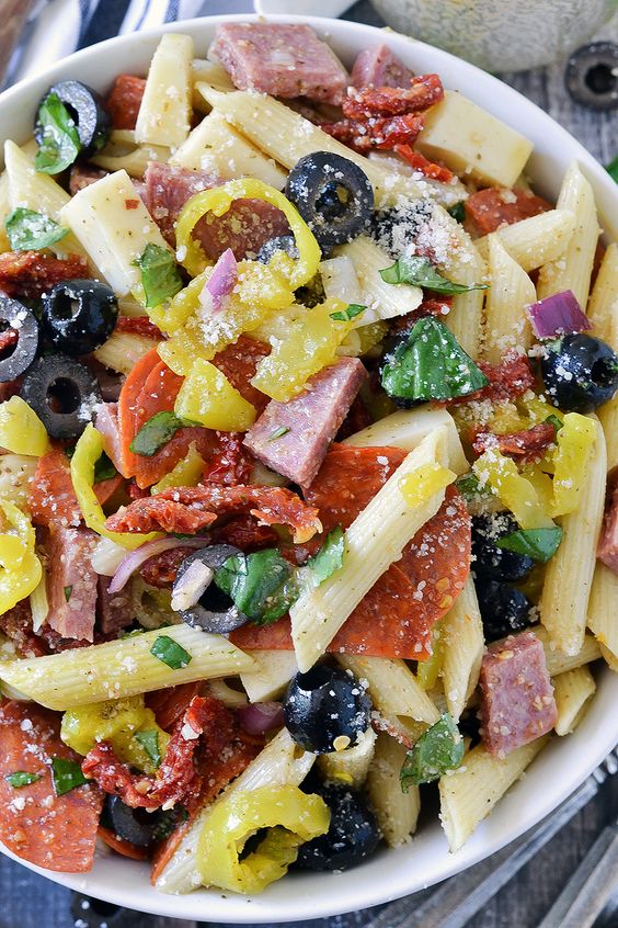 This Italian Pasta Salad is loaded with salami, pepperoni, cheese, sun-dried tomatoes, banana peppers, olives, basil, and tossed in an easy Italian dressing!