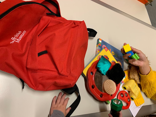 A red British Museum Gallery Back pack for under 5s with the contents on show