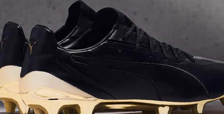gold and black football boots