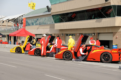 Yellow and Red Ferrari FXX's all lined up - race preparation