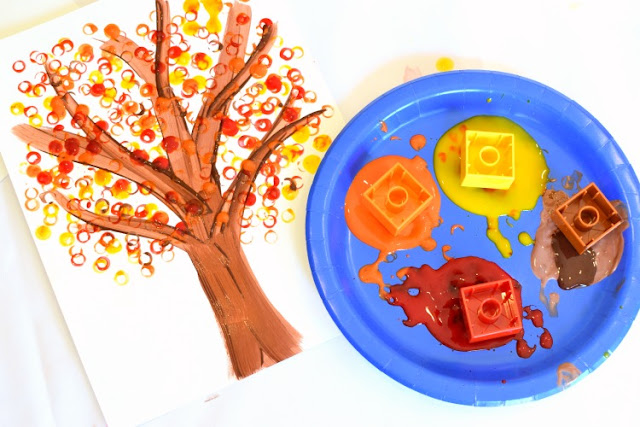 LEGO Stamped Fall Tree Craft for Kids. Use LEGO or DUPLO bricks to paint leaves in beautiful fall colors! Fun autumn printmaking activity for preschool, kindergarten, or elementary.
