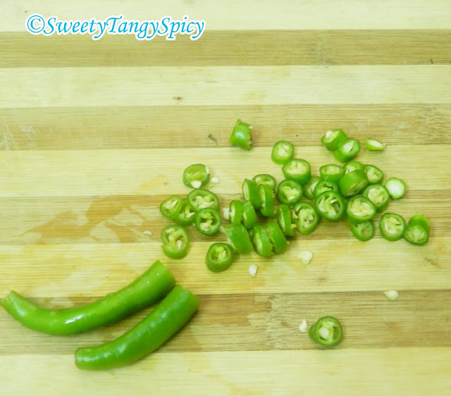 Chopping green chilies.