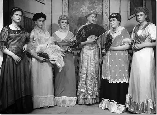 Six femulators in period costumes.