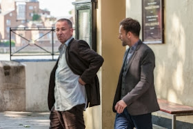 Sean Pertwee as Gareth Lestrade and Jonny Lee Miller as Sherlock Holmes in CBS Elementary Season 2