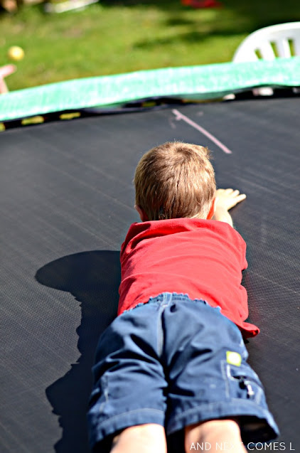 Clock activity for kids using sidewalk chalk on the trampoline