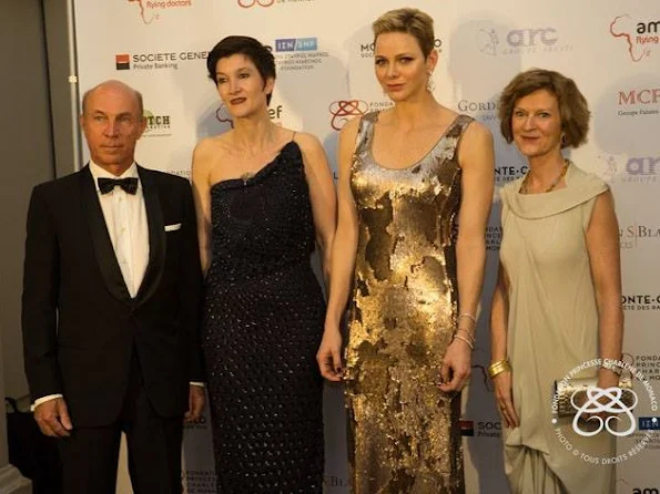 Princess Charlene wore AKRIS Sequined Gown in Gold Metallic at AMREF Gala in evening