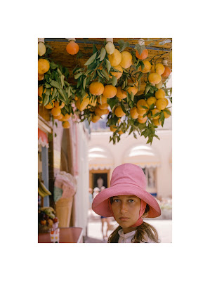 color photograph of young woman by orange tree