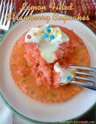 Lemon Filled Strawberry Cupcakes, features spring flavors. Fluffy strawberry cupcakes, filled and topped with lemon frosting. | Recipe developed by www.BakingInATornado.com | #recipe #cake