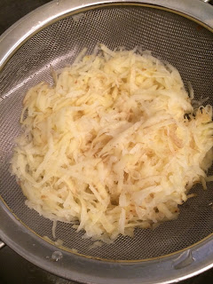 grated potatoes in a frying pan
