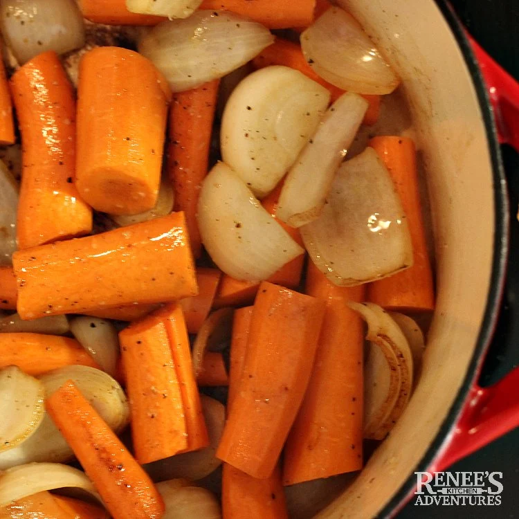 Process Photo for Dutch Oven Pot Roast by Renee's Kitchen Adventures carrots and onions being browned in dutch oven, over head view