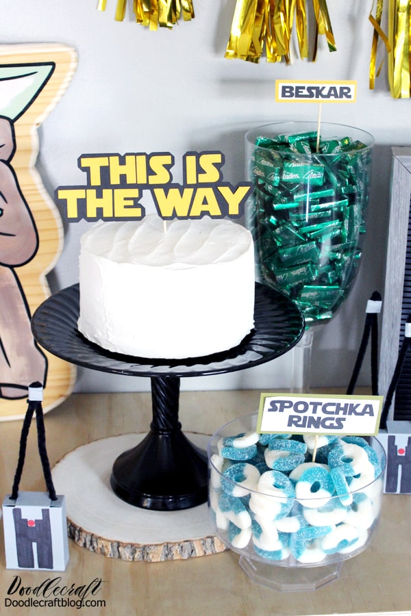 Make a simple frosted cake with a cake topper "this is the way" perfect for a Mandalorian themed birthday party diy.