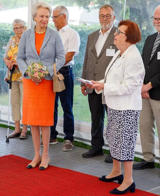Benedikte wore a orange wool dress and grey jacket.  I.P. Nielsen Foundation provides support to children and young people in Southern Jutland