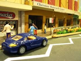 Quarter inch scale modern Australian town street scene with supermarket and Christian Outreach Centre.