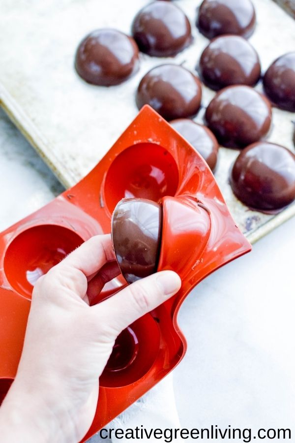 Removing chocolate shells from a silicone mold. Set them aside on the cold metal tray.