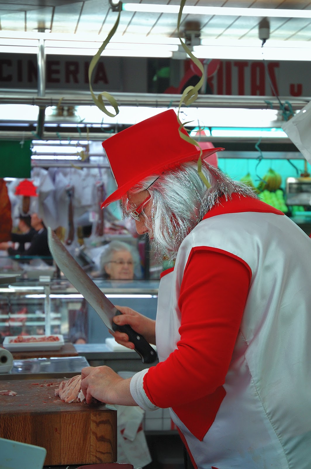 Butcher lady holding carving knife and wearing carnival costume