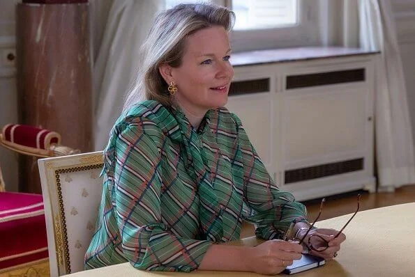 Queen Mathilde wore a green striped pussy-bow silk blouse by Natan, Dries Van Noten, Giorgio Armani and Red Valentino