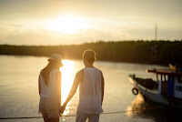 Couple holding hands before the sunset