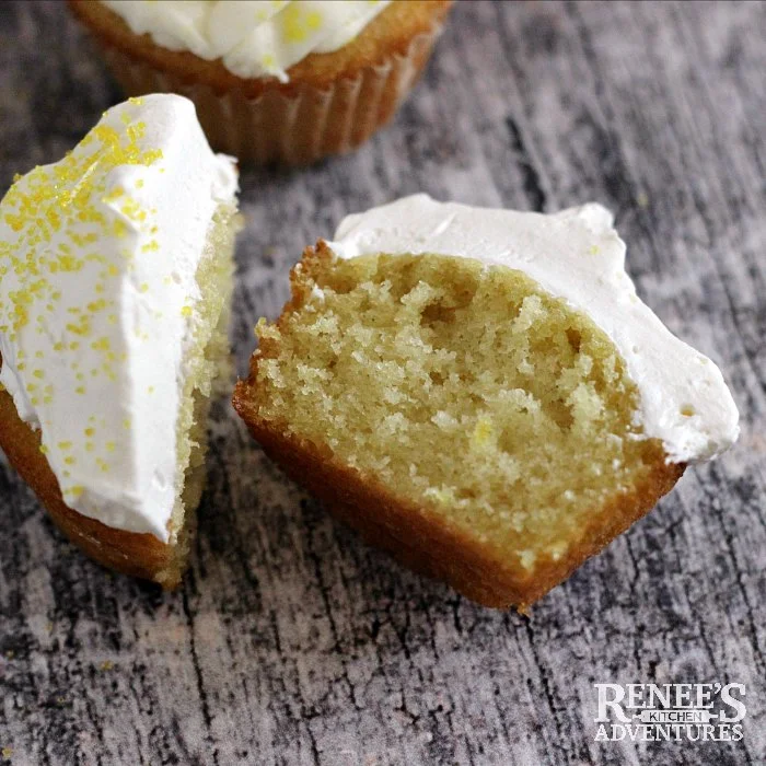 Easy Lemon Cupcakes by Renee's Kitchen Adventures cut in half to see the inside of the cupcake