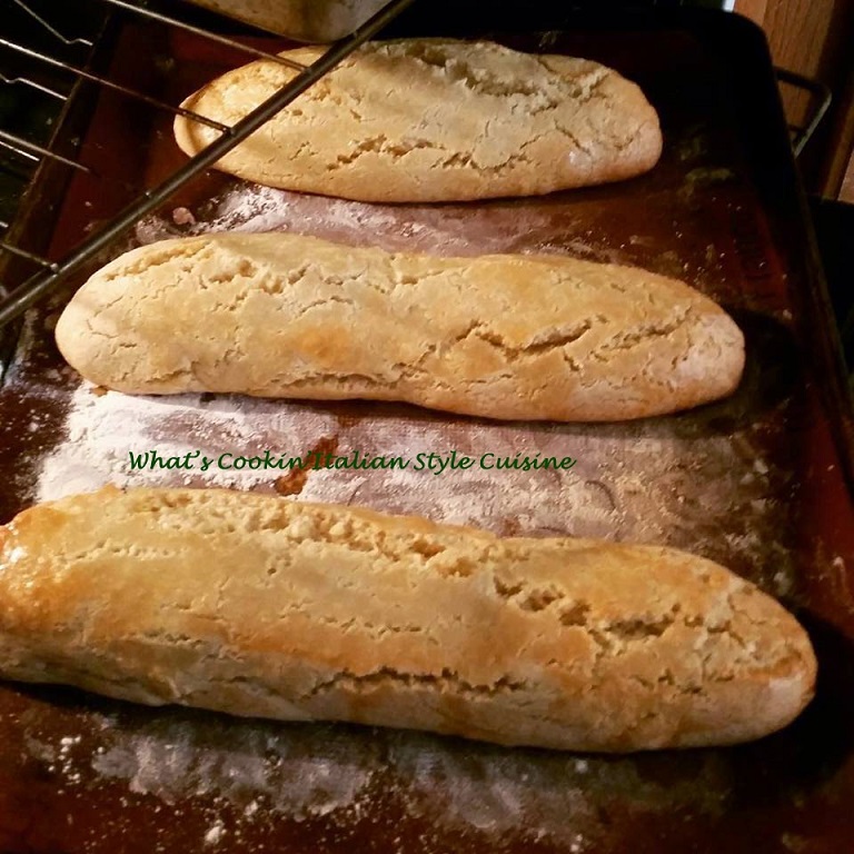 loaves of biscotti baking on a cookie sheet