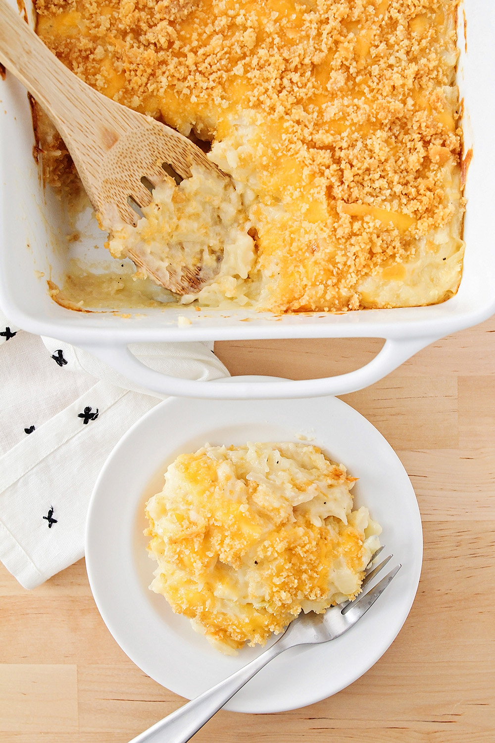 This cheesy potato casserole is the most delicious comfort food! It's made totally from scratch, with a creamy homemade sauce and so much cheesy goodness!