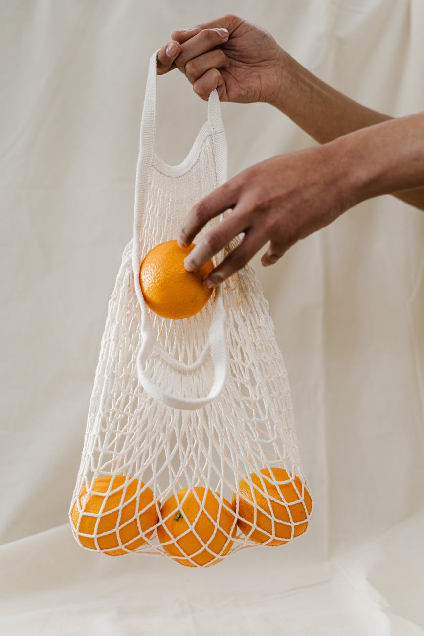 woman using a reusable farmer's market bag