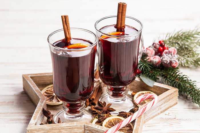 How to make mulled wine in a Crockpot slow cooker. The easy recipe can be made with brandy or without. Make it sugar free with maple syrup or honey so it's still sweet. This classic fall drink is also good for Thanksgiving or Christmas for the holiday season. Use mulling spices or a mix of dried spices for the best simple mulled wine recipe. #mulledwine #drink #wine #recipe