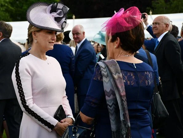 Kate Middleton wore a bespoke soft pink coatdress by Alexander McQueen. Loeffler Randall clutch. Countess of Wessex