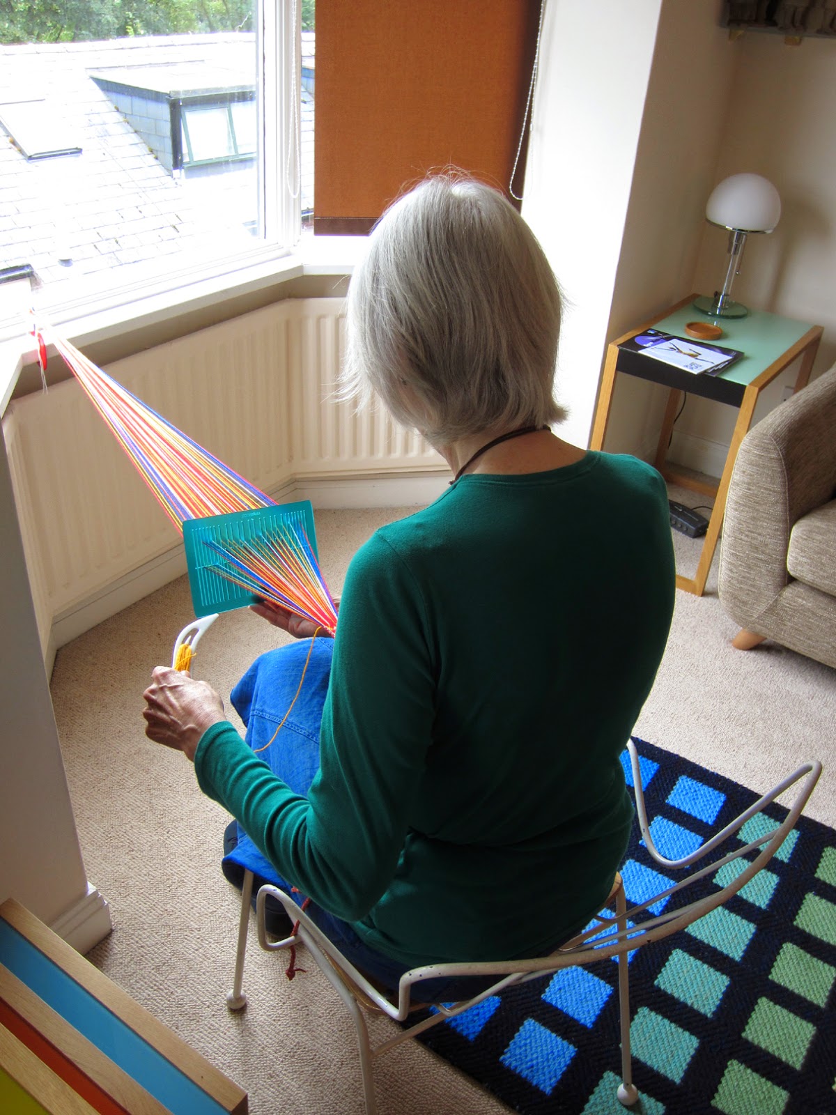 Durham Weaver weaving with a double slotted heddle.