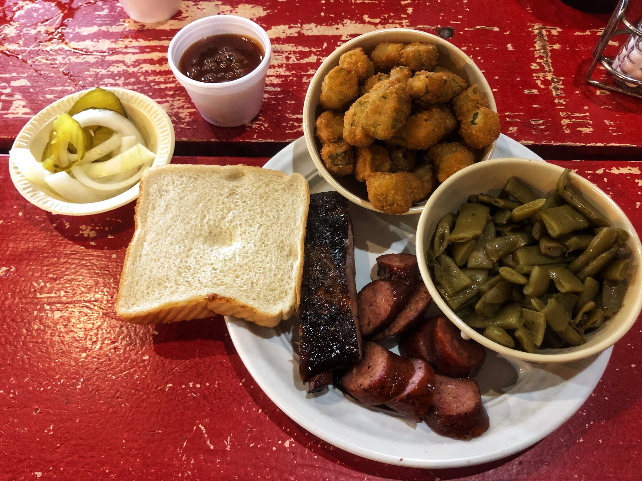 smoked sausage, pork rib, green beans, fried okra, and Texas toast at Hammond's BBQ