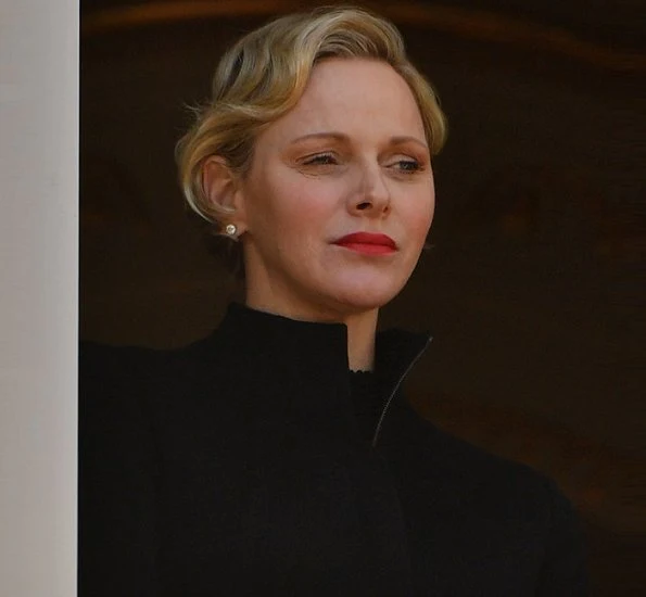 Prince Albert, Princess Charlene and Prince Jacques. Princess Charlene wore a long coat by Akris. gold wedding ring