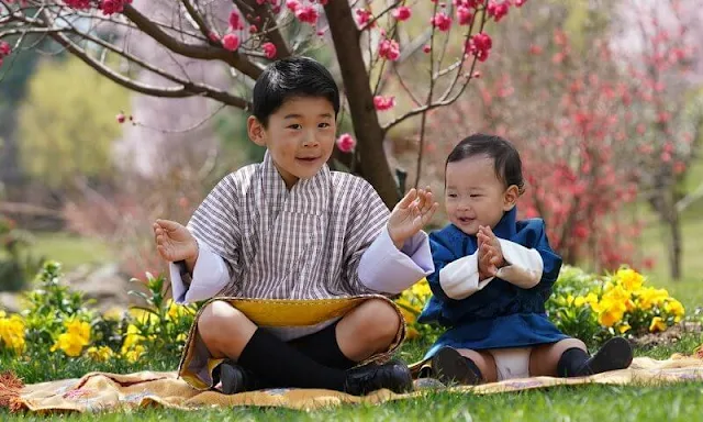 King Jigme Khesar Namgyel Wangchuck, Queen Jetsun Pema, Gyalsey Jigme Namgyel and Gyalsey Ugyen. Satin dress