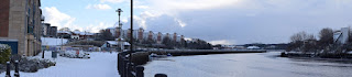 A panoramic picture looking west along a snowy River Tyne