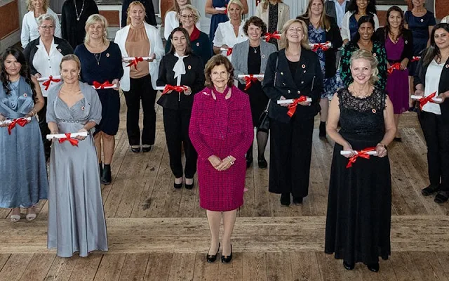 Queen Silvia of Sweden wore a red wool jacket and skirt