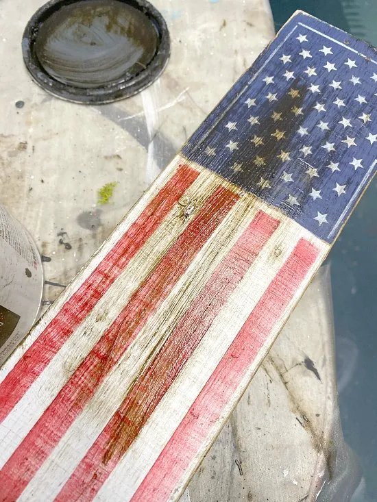 staining the American flag on a wooden stake