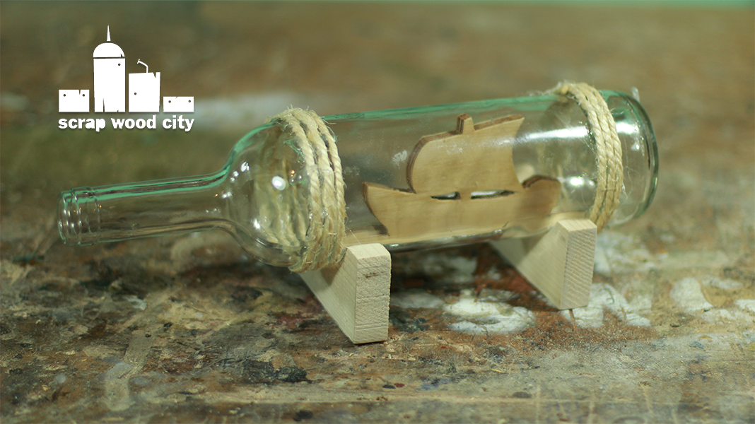 scrap wood city Place a boat in a cut glass bottle