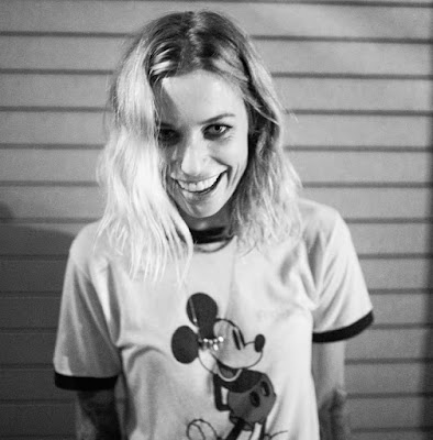 Gin Wigmore, smiling and wearing a Mickey Mouse t-shirt