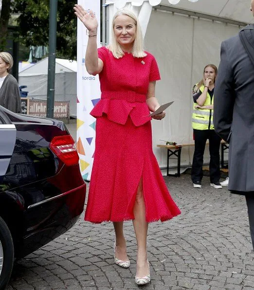 Mette Marit is wearing Oscar de la Renta wool-blend tweed peplum jacket, and frayed midi skirt, Malone Souliers Brenda stripe pumps