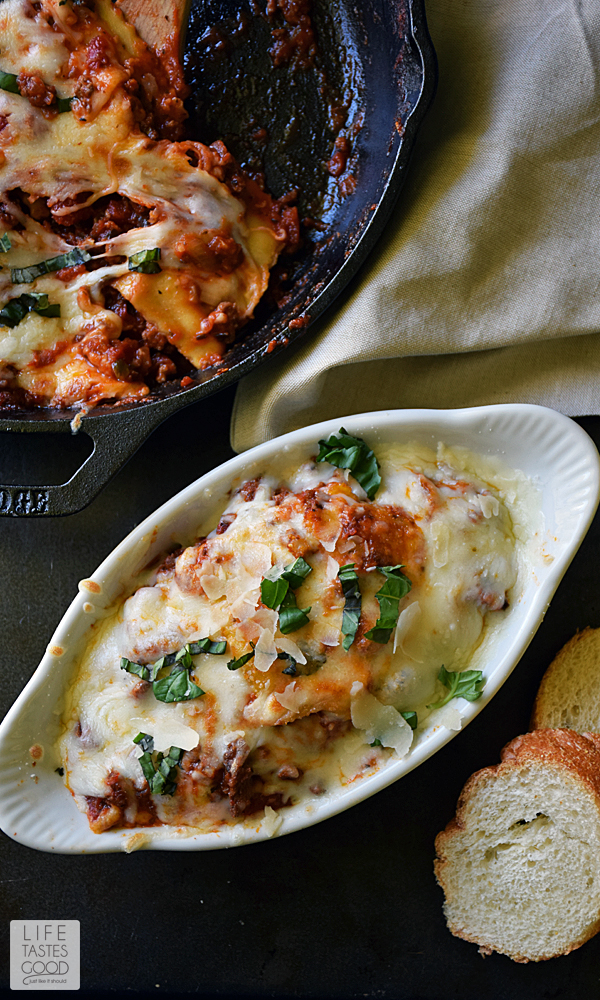 Cheese ravioli swimming in an easy Tuscan beef sauce and smothered in 2 different kinds of cheese, brings a Taste of Italy to the dinner table in under 30 minutes! This Cheesy Baked Ravioli in a Skillet | by Life Tastes Good is a deliciously easy recipe the whole family will love! #LTGrecipes