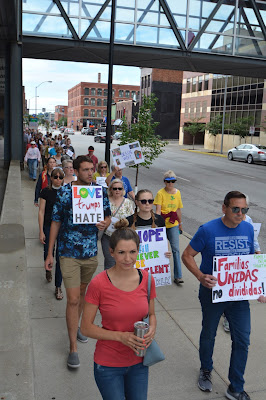 ID: in 2018 two hundred Iowans take part in a Jericho Walk around the Federal Building in Des Moines in support of immigrants and in opposition to the unjust immigration system.