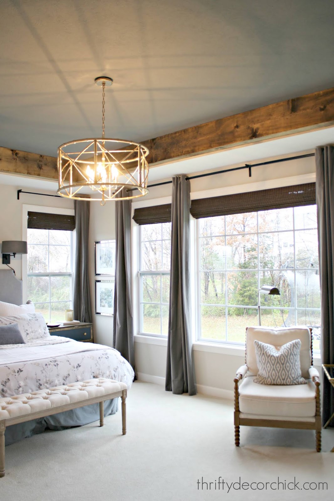 Dark ceiling in master bedroom with wood beams