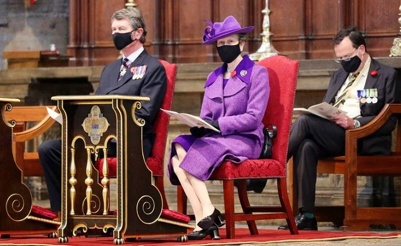 Princess Anne wore an eye-catching purple coat and matching hat, a pale lilac scarf and black knee-high boots