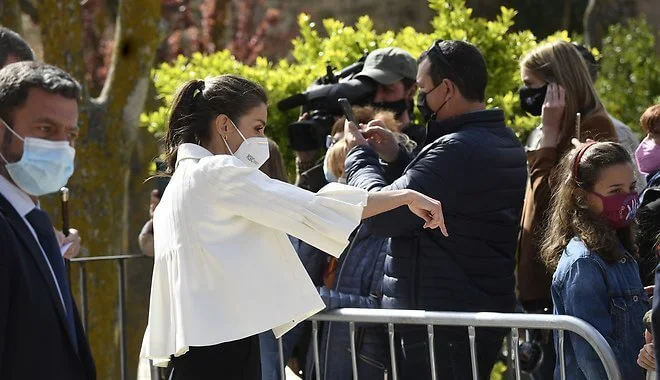 Queen Letizia wore a stripe wool sweater and trousers from Hugo Boss, and new black maysli suede slingback pumps from Manolo Blahnik