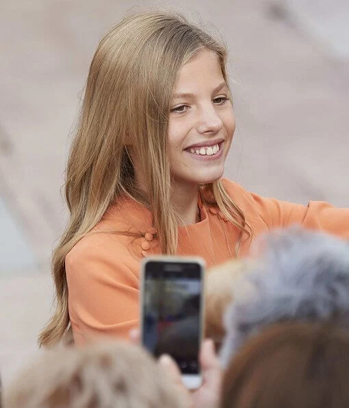 Queen Letizia wore grey coat dress, Crown Princess Leonor wore a Mango pattern jacket and Infanta Sofía wore a coral Mango dress