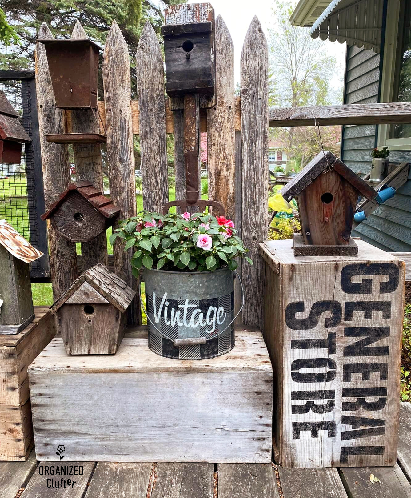 Rustic Birdhouse Display Assembled From Crates, Fence Picket, and a
