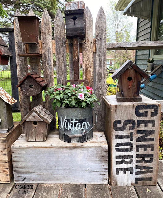 Photo of rustic birdhouses and annuals displayed on old crates