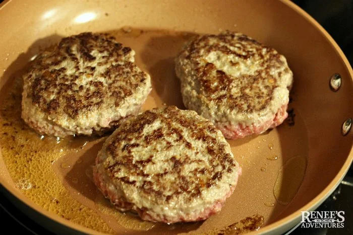 Slow Cooker Salisbury Steak patties browning in pan