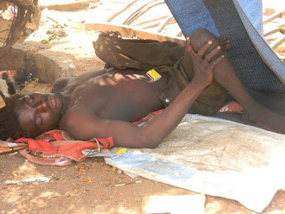 A mad man lying on the streets of Accra