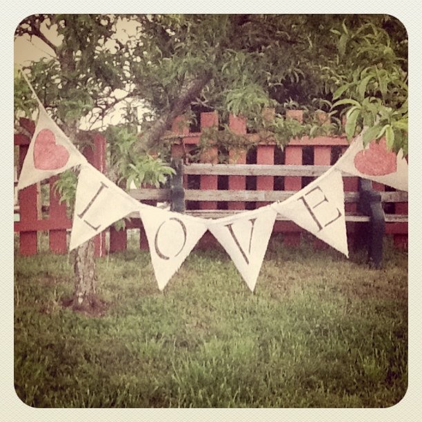 sharpie decorated banner hanging outdoors that reads LOVE 